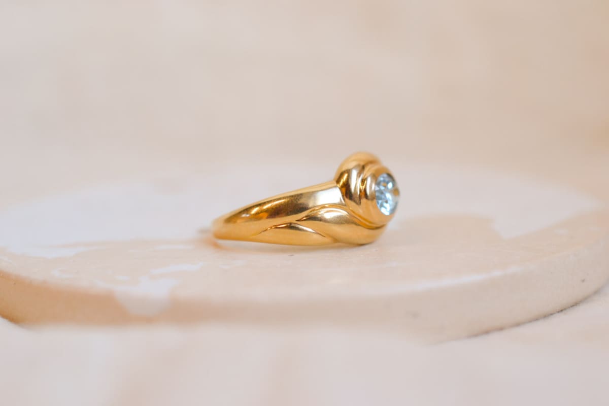 Jonc volute en Or jaune 18 carats sertie clos d'une Topaze
