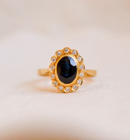 Bague Marguerite ancienne en Or jaune 18 carats centrée d'un Saphir entouré de Diamants